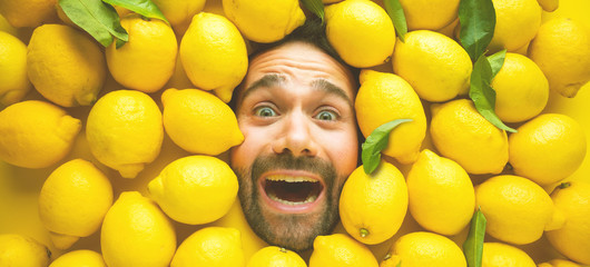 Mann mit Zitrone, Konzept für die Lebensmittelindustrie. Gesicht vom lachenden mann in der...
