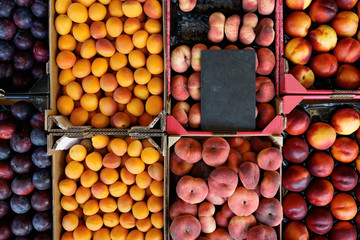 fresh fruit in crates at the market. blank price tag