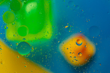 Micro molecular abstract pattern of colored oil bubbles on water. 