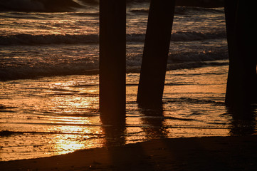 Sunset behind silhouette of Venice Fishing Pier in Venice, CA