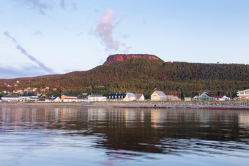 The Ste. Anne Mount dominating the famous Percé village and bay seen during a beautiful summer sunrise, Quebec, Canada