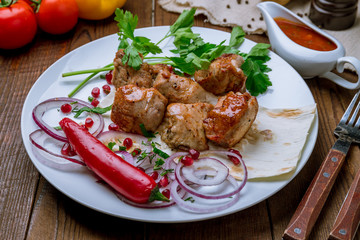 Kebab of pork on wooden table