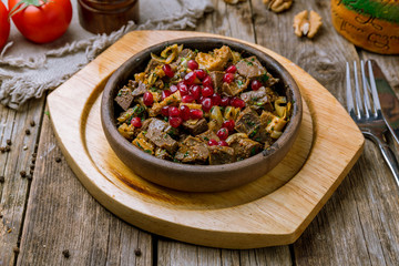 kuchmachi Georgian cuisine on wooden table
