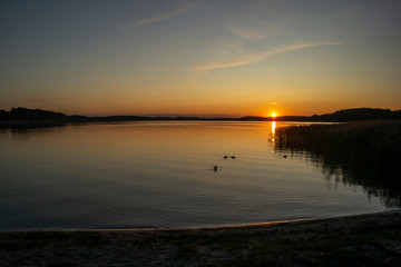 Fototapeta na wymiar Beautiful summer sunset on the lake. Euro-trip