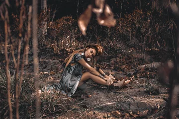 Foto op Canvas beautiful young boho style woman sitting on ground outdoors © zolotareva_elina