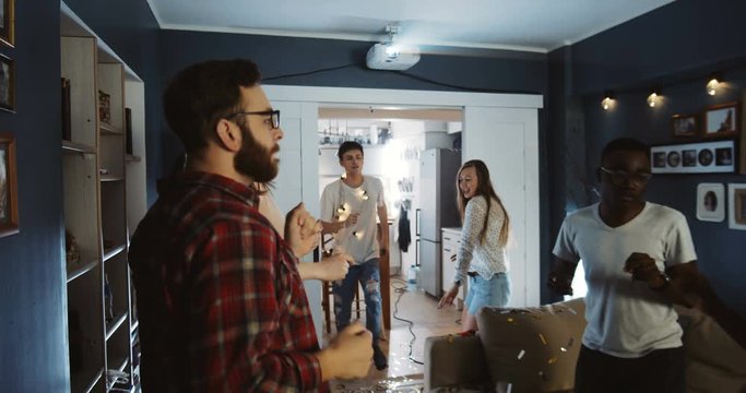 Multiethnic happy young millennials having amazing fun dancing together at holiday party celebrating life slow motion.