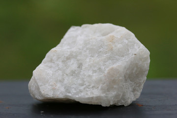 fluorite stone mineral crystal sample for science and geology isolate on green background