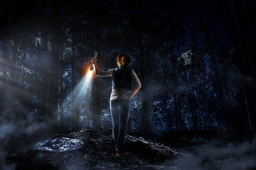Young woman holding a flashlight