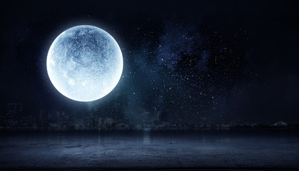 Fototapeta na wymiar Full moon over dark night city