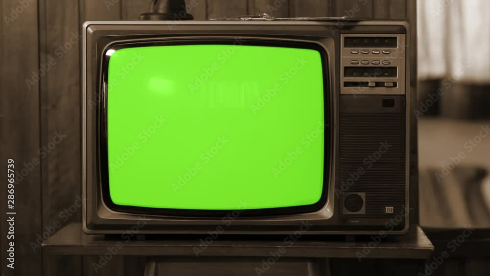 Wall mural vintage television set green background with noise and static. sepia tone. you can replace green scr