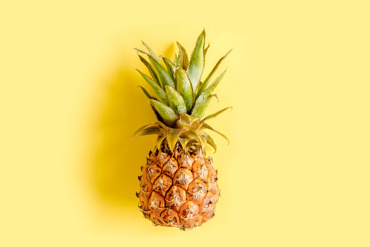 Top view pineapple isolated on yellow background with copy space for text. Template blog social media. Food concept. Minimal style. flat lay