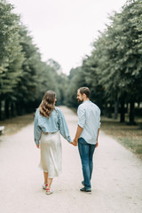  love story in Berlin. couple walking on alley in Park..