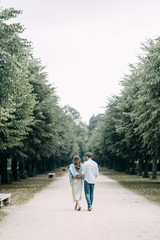 Fototapeta na wymiar love story in Berlin. couple walking on alley in Park..