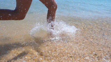 Girls run barefoot on the sand beach. Slow motion.