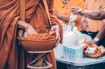 Put alms to make merit in Buddhism