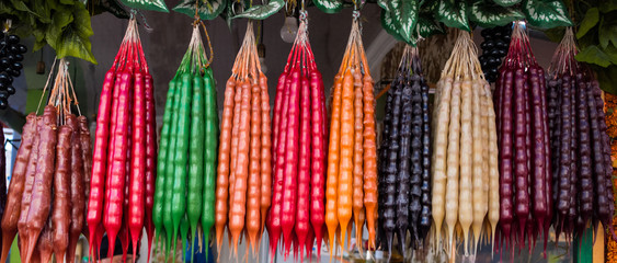 Churchkhela - sweet dessert in Georgia. Georgian traditional candy with wheat flour, nuts,...