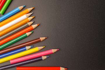 Colour pencils against chalkboard, for copyspace