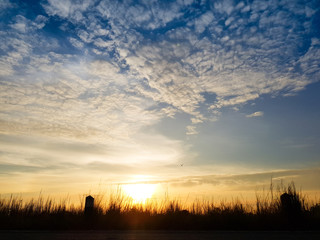 Beautiful skyscape clear blue sky and golden cloud background during sunset. Clearing day and Good weather in the evening.