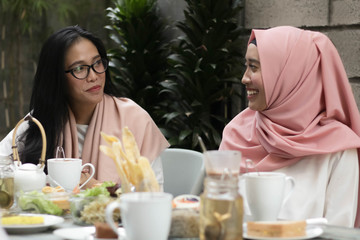 women having conversation in middle of lunch