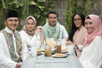 group of happy young muslim having dinner outdoor