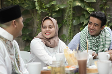 group of happy young muslim having dinner outdoor
