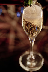 Close-up of a bottle serving champagne in an elegant glass. Concept of celebration.