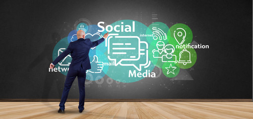 Businessman holding a cloud of social media network icon