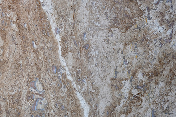 Wall of travertine with stone layers of different colors. Close up architecture macro photography. Creative wallpaper photography.