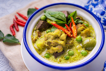 Thai food chicken green curry on dark wooden background. top view , Free space for text input