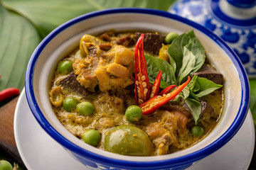 Thai food chicken green curry on dark wooden background. top view , Free space for text input