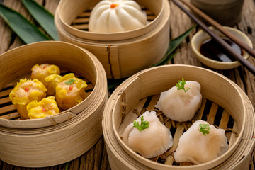 Dim sum, Dim Sum on the wooden table, top view and space for text input , Dim Sum (Chinese food) in steamed bamboo