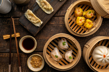 Dim sum, Dim Sum on the wooden table, top view and space for text input , Dim Sum (Chinese food) in...