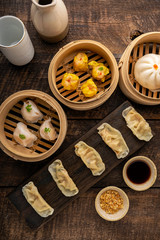 Dim sum, Dim Sum on the wooden table, top view and space for text input , Dim Sum (Chinese food) in steamed bamboo