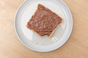 Chocolate nuts cream on a bread slice