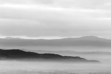 A view of Umbria valley with hills and mist