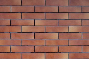 Wall of red-yellow brick. Close-up.