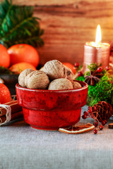 Bowl with walnuts and Christmas decorations in the background.