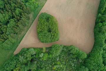 plowed agriculture field in nature park, aerial