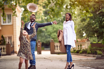Obraz premium Mother and father with pupil having fun in park after school.