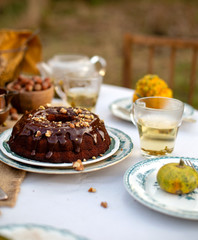 chocolate bundt cake with chocolate glaze on vintage plates on table with grey tablecloth