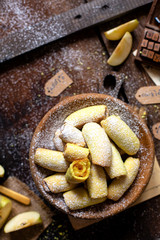 homemade shortbread yellow baked rolled cookies or bagels with apple jam in wooden round plate