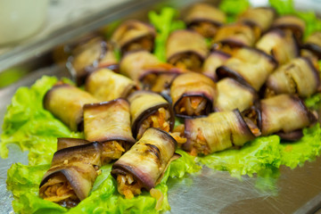 Stuffed eggplant on lettuce in a restaurant closeup.