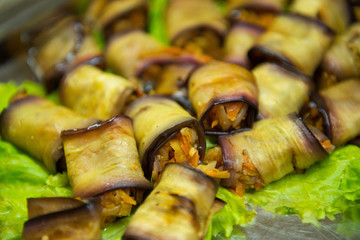 Stuffed eggplant on lettuce in a restaurant closeup.