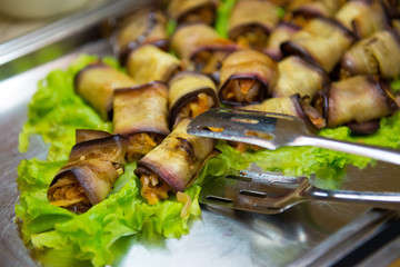 Stuffed eggplant on lettuce in a restaurant closeup.