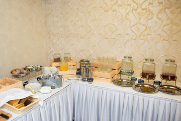 Table with desserts and juices in the interior of the restaurant.