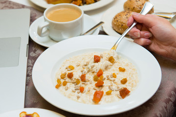 Oatmeal with dried fruits during breakfast.