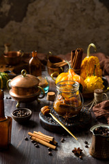 homemade pumpkin spice mix in glass jar on rustic wooden table