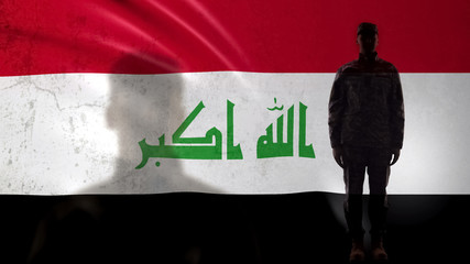 Iraqi soldier silhouette standing against national flag, proud army sergeant