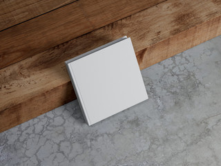 White square blank Book Mockup with hard cover standing near wood stair