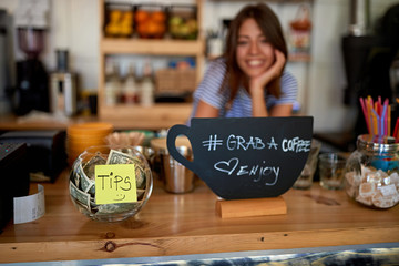 tips jar and grab sign for coffee at new cafe..